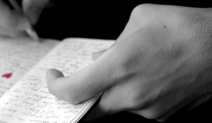 A man holding notes about their experiences.