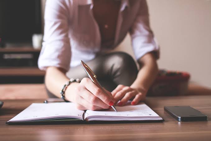 Writing down thoughts on paper.